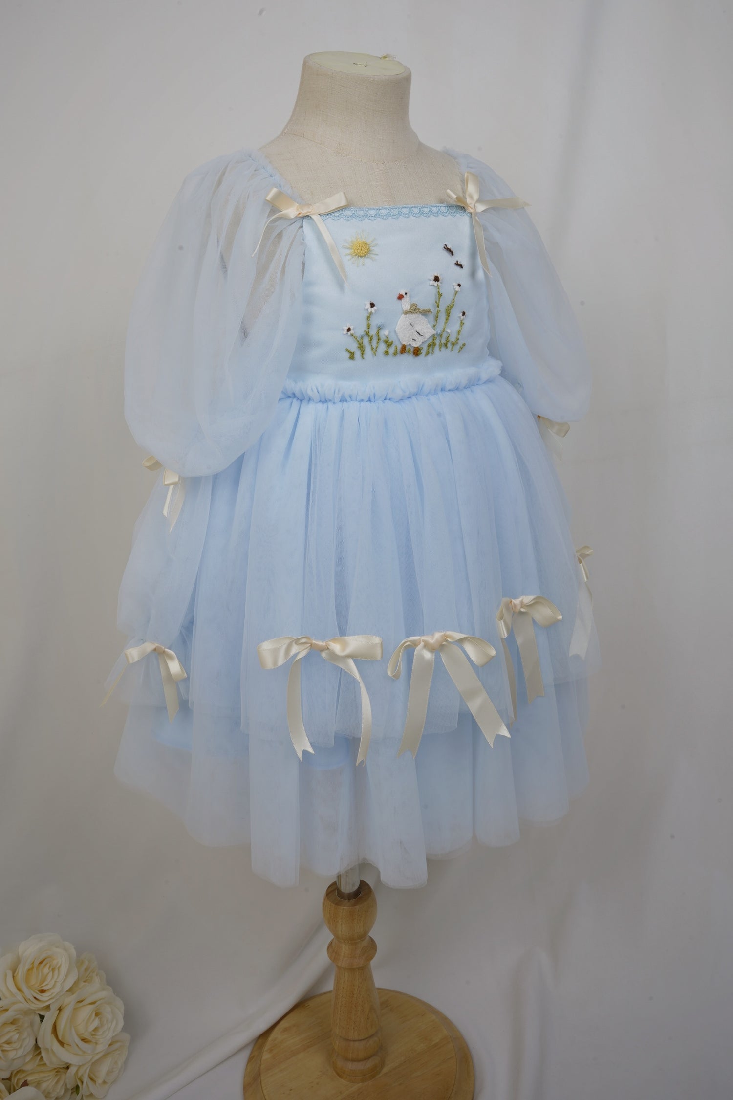 side angle showing layered tulle skirt and bows