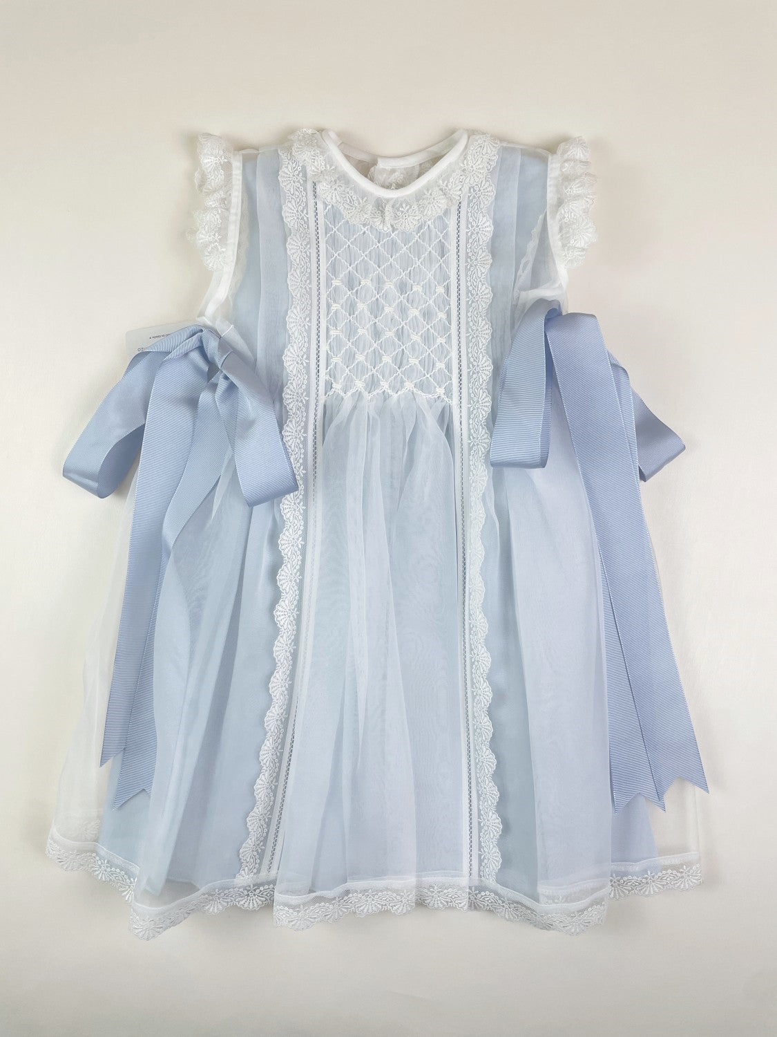 Luxe crystal 2-piece Handsmocked Blue Baby Dress White- Blue Lining/Bow's Beige / 18M Luxe crystal 2-piece Handsmocked Blue Baby Dress White- Blue Lining/Bow's Beige / 18M