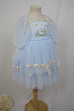 side angle showing layered tulle skirt and bows