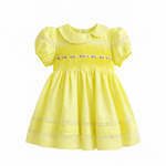 lemon yellow baby girl dress with pintuck bodice and lace hem on hanger